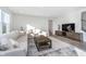 Inviting living room boasts a large sofa, stylish coffee table, and media center, perfect for relaxation at 19477 Quilling Ln, Noblesville, IN 46062
