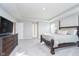 Relaxing main bedroom features a king bed, dark wood furniture, and a view into the en suite bathroom at 19477 Quilling Ln, Noblesville, IN 46062
