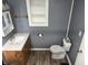 Bathroom including toilet and sink, designed with functional storage and simple, clean lines at 2105 N Cherry St, Columbus, IN 47201