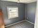 Simple bedroom showcasing neutral walls, large window, and natural light, creating a calm and inviting atmosphere at 2105 N Cherry St, Columbus, IN 47201
