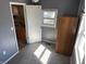 Cozy bedroom featuring a window and wood wardrobe, seamlessly connected to a kitchen area for convenience at 2105 N Cherry St, Columbus, IN 47201