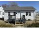Charming home with a black porch and white siding, offering curb appeal and a welcoming entrance at 2105 N Cherry St, Columbus, IN 47201