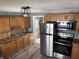 Kitchen with wooden cabinetry, stainless steel appliances, and contemporary hardware at 2105 N Cherry St, Columbus, IN 47201