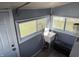 Practical laundry room with utility sink, multiple windows, and convenient access to the outdoors at 2105 N Cherry St, Columbus, IN 47201