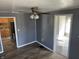 Living room leading to kitchen and bathroom, enhanced by modern ceiling fan and stylish wood-look floors at 2105 N Cherry St, Columbus, IN 47201