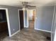 Neutral living room featuring wood-look floors, gray walls, and view into adjacent spaces at 2105 N Cherry St, Columbus, IN 47201