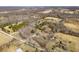 An aerial view captures the property surrounded by trees and several houses nearby at 2305 Bill Smith Rd, Martinsville, IN 46151