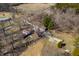 Aerial view showing the home with a basketball court, outbuildings, and surrounding wooded area at 2305 Bill Smith Rd, Martinsville, IN 46151