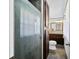 View of bathroom with shower, toilet, and brown vanity with granite top and wood trimmed mirror at 2305 Bill Smith Rd, Martinsville, IN 46151
