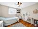 A cozy bedroom featuring a desk, natural lighting, wood floors, and chair seating at 2305 Bill Smith Rd, Martinsville, IN 46151