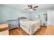 Bright bedroom featuring hardwood floors, a ceiling fan, and light blue walls at 2305 Bill Smith Rd, Martinsville, IN 46151