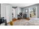 Bright bedroom featuring a work area, closet, large window, and patterned area rug on hardwood flooring at 2305 Bill Smith Rd, Martinsville, IN 46151