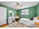 This bedroom features a ceiling fan, natural lighting, neutral carpet, and a comfortable lounge area at 2305 Bill Smith Rd, Martinsville, IN 46151