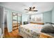 Spacious bedroom featuring a closet mirror, a ceiling fan, natural lighting, and a comfortable bed set at 2305 Bill Smith Rd, Martinsville, IN 46151