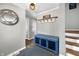 Foyer showcases a decorative round mirror, a blue storage bench, and a staircase leading to the upper level at 2305 Bill Smith Rd, Martinsville, IN 46151