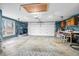 Spacious garage featuring a workbench, painted floor, storage shelves, and overhead lighting at 2305 Bill Smith Rd, Martinsville, IN 46151