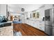 Bright kitchen with white cabinets, granite countertops, and stainless steel appliances, seamlessly connecting to the dining area at 2305 Bill Smith Rd, Martinsville, IN 46151