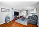 Cozy living room showcasing hardwood floors, a leather sofa, and stylish decor for comfortable living at 2305 Bill Smith Rd, Martinsville, IN 46151