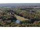 A lovely aerial view showcasing the property, the pond, and a lush green landscape at 2387 Bill Smith Rd, Martinsville, IN 46151