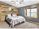 Cozy bedroom with rustic wood accent wall, plush carpeting, and bright windows at 2387 Bill Smith Rd, Martinsville, IN 46151