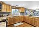 Spacious kitchen featuring wood cabinets, stainless sink under a large window, and laminate countertops at 2387 Bill Smith Rd, Martinsville, IN 46151
