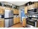 Modern kitchen with stainless steel appliances and abundant wood cabinetry at 2387 Bill Smith Rd, Martinsville, IN 46151