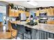 Kitchen boasting stainless appliances, wood cabinets with decor, and a unique corrugated metal kitchen island at 2387 Bill Smith Rd, Martinsville, IN 46151