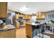 Well-appointed kitchen featuring warm wood cabinetry, stainless steel appliances, and breakfast bar seating at 2387 Bill Smith Rd, Martinsville, IN 46151