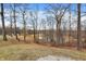 The property offers a serene pond view with a glimpse of a swing set in the trees at 2387 Bill Smith Rd, Martinsville, IN 46151