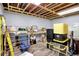 Basement with exposed ceiling and laminate flooring, filled with storage items at 2389 Bill Smith Rd, Martinsville, IN 46151