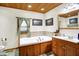 Well-lit bathroom with a bathtub and wooden cabinets and a wooden ceiling at 2389 Bill Smith Rd, Martinsville, IN 46151