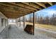 View of the home's exterior, showing a covered area, detached garage, and wooded surroundings at 2389 Bill Smith Rd, Martinsville, IN 46151