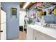 Functional laundry room with washer, dryer, storage shelves, and blue painted walls at 2389 Bill Smith Rd, Martinsville, IN 46151