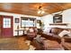 Cozy living room with wood ceiling, leather furniture, and unique décor at 2389 Bill Smith Rd, Martinsville, IN 46151
