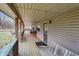 Inviting covered front porch with wood flooring, swing, and decorative touches at 2389 Bill Smith Rd, Martinsville, IN 46151