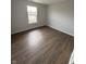 This bedroom features hardwood floors and a window with lake views at 2418 Shorewood Dr, Lebanon, IN 46052