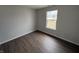 This bedroom features hardwood floors and a window at 2418 Shorewood Dr, Lebanon, IN 46052