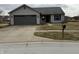 Charming single-story home with a well-manicured lawn and mature trees at 2418 Shorewood Dr, Lebanon, IN 46052