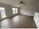 Bright living room features hardwood floors and a door to the backyard at 2418 Shorewood Dr, Lebanon, IN 46052