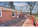 This backyard features a red-railed wooden patio deck for outdoor enjoyment at 244 Corottoman Ct, Avon, IN 46123