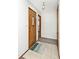 Inviting entryway featuring neutral tile flooring, a decorative front door, and convenient coat closet at 244 Corottoman Ct, Avon, IN 46123