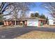 Charming red brick ranch-style home with a well-maintained asphalt driveway and attached two-car garage at 244 Corottoman Ct, Avon, IN 46123
