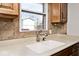 Close-up of kitchen sink with view of a large window providing natural light to the space at 244 Corottoman Ct, Avon, IN 46123