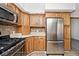 Well-equipped kitchen with stainless steel appliances, including gas range, microwave, and refrigerator at 244 Corottoman Ct, Avon, IN 46123