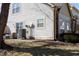 Back exterior view of the two-story home showcasing white siding and a concrete backyard patio at 2449 Chaseway Ne Ct # Blk B, Indianapolis, IN 46268
