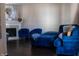 Inviting living room showcasing a fireplace and cozy blue upholstered furniture on hardwood floors at 2449 Chaseway Ne Ct # Blk B, Indianapolis, IN 46268
