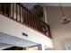 View to the upper level with wood railing and view of a chandelier at 2449 Chaseway Ne Ct # Blk B, Indianapolis, IN 46268