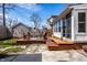 Wooden deck in backyard with outdoor seating, complimented by stone path and a well maintained lawn at 2615 Kessler Blvd E Dr, Indianapolis, IN 46220