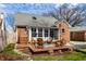 Backyard featuring outdoor seating on a deck, complemented by lush greenery and a well-manicured lawn at 2615 Kessler Blvd E Dr, Indianapolis, IN 46220
