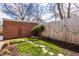 Landscaped backyard with a mature tree and a rock-lined water feature adding charm at 2615 Kessler Blvd E Dr, Indianapolis, IN 46220